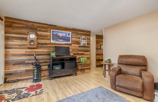 living room with wood walls and light hardwood / wood-style floors