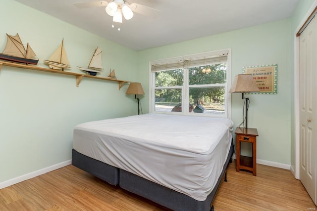 bedroom featuring light wood-type flooring, a closet, and ceiling fan