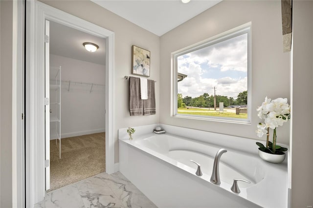 bathroom with a bathtub and tile patterned flooring