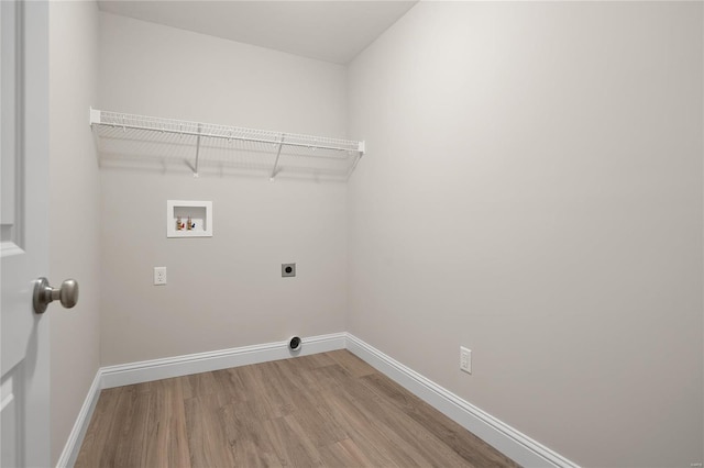 clothes washing area featuring electric dryer hookup, hardwood / wood-style flooring, and washer hookup