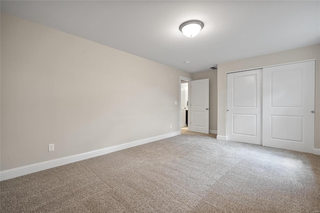 unfurnished bedroom with a closet and carpet