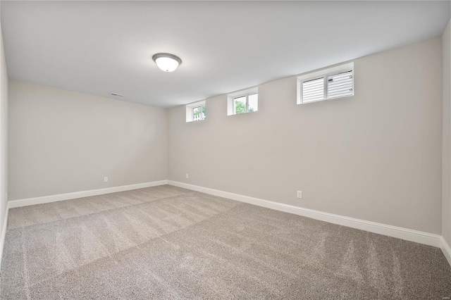 basement featuring light colored carpet