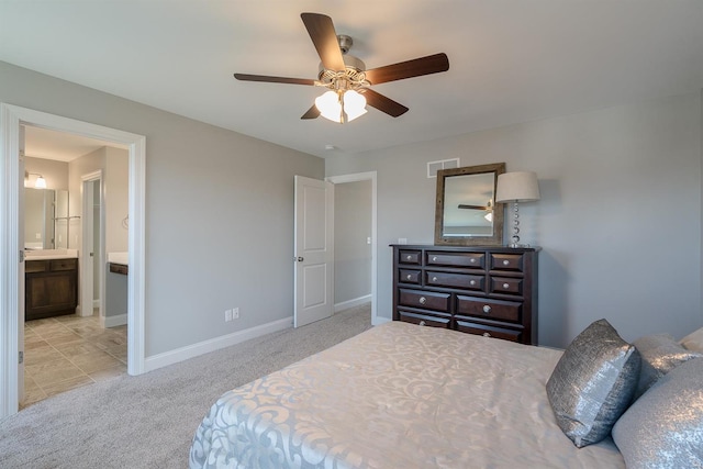 carpeted bedroom with ceiling fan and connected bathroom