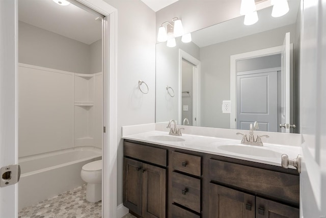 full bathroom with tile patterned flooring, double sink vanity, washtub / shower combination, and toilet