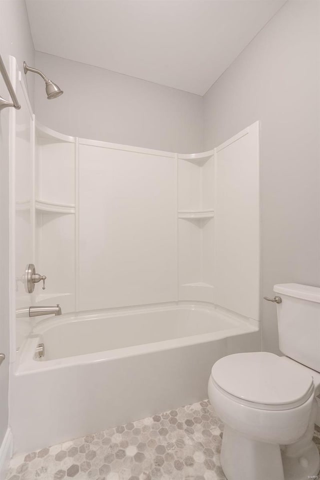 bathroom with tile patterned flooring,  shower combination, and toilet