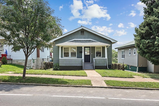 bungalow-style house with a front yard