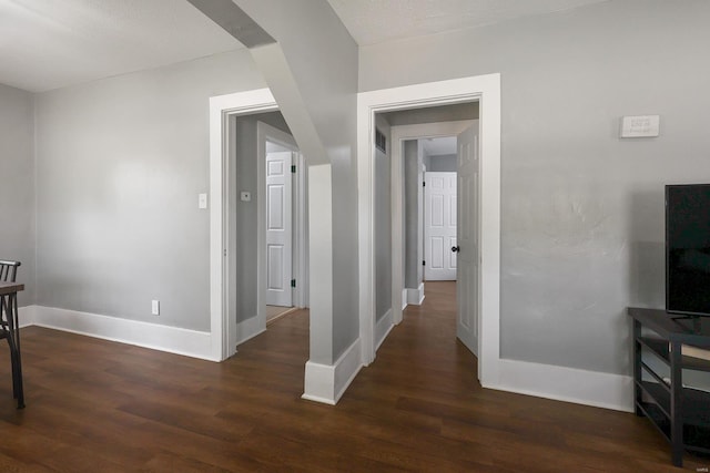 corridor with hardwood / wood-style floors and a textured ceiling