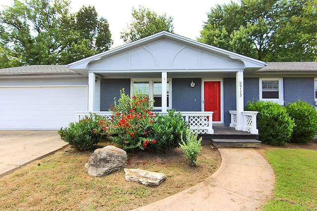 single story home featuring a porch and a garage