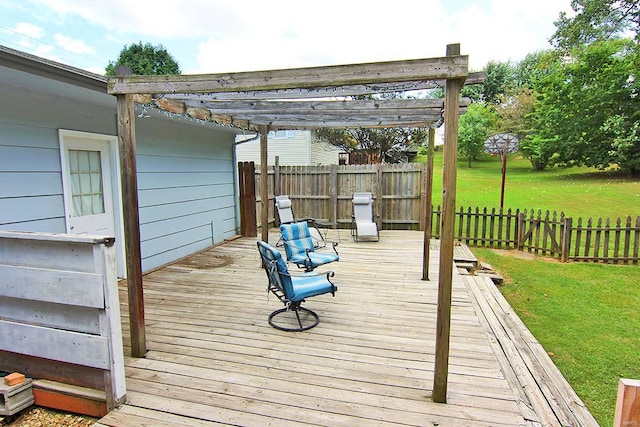 wooden deck featuring a pergola and a yard