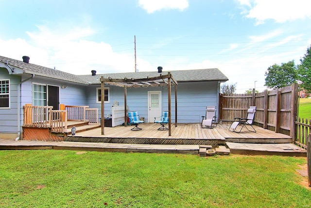 rear view of property with a pergola, a lawn, and a deck