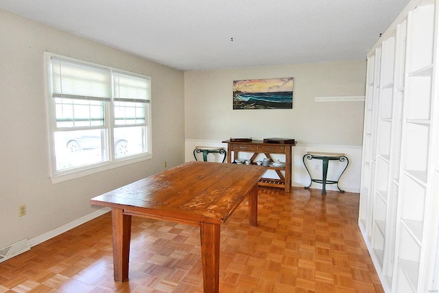 dining space featuring light parquet flooring and plenty of natural light