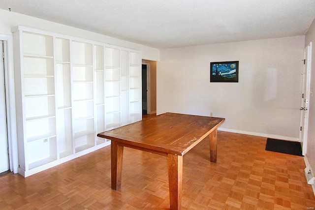 interior space featuring a textured ceiling and parquet floors