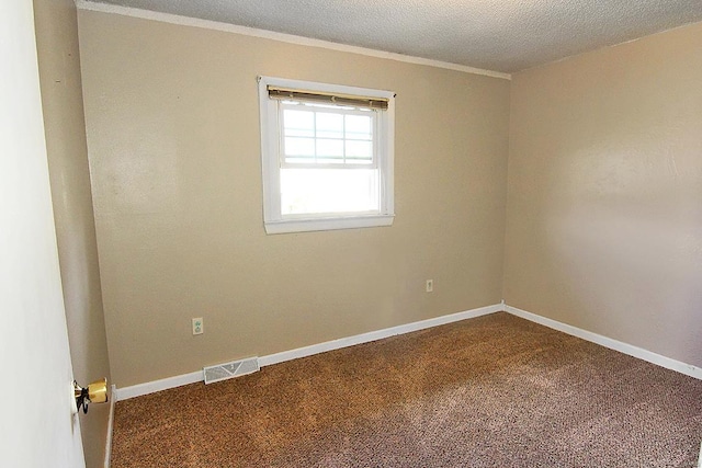 unfurnished room with a textured ceiling and carpet flooring