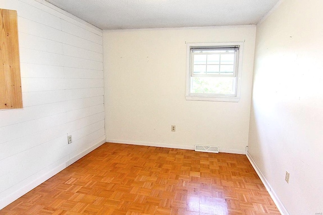 spare room featuring parquet floors