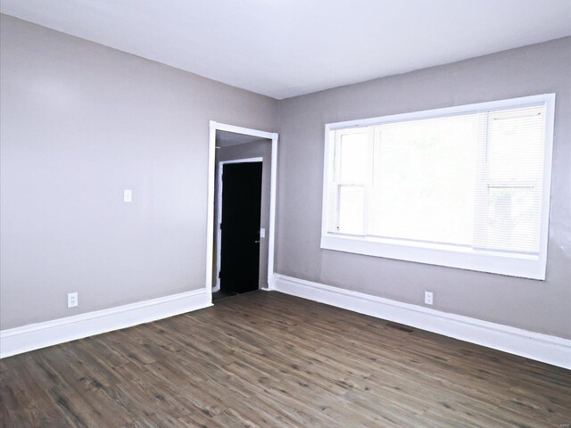 empty room featuring plenty of natural light and hardwood / wood-style floors