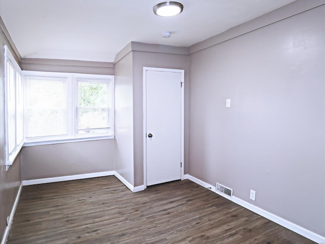 unfurnished bedroom with dark hardwood / wood-style flooring