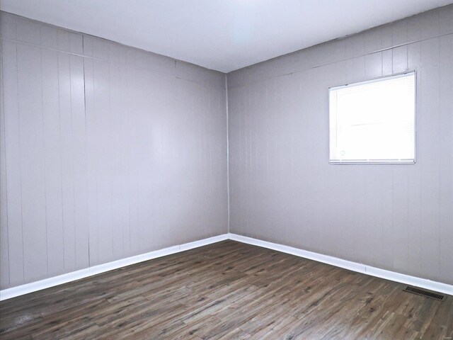 unfurnished room with hardwood / wood-style flooring