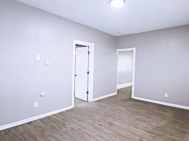 spare room featuring wood-type flooring