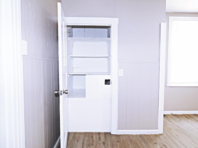 laundry area featuring light wood-type flooring