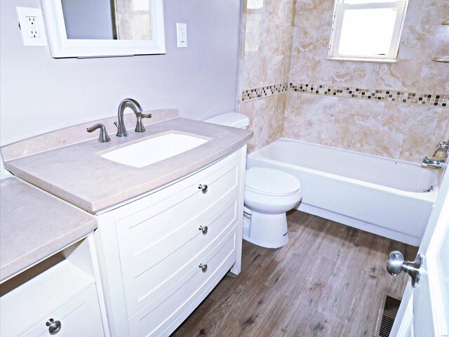 bathroom with toilet, hardwood / wood-style flooring, and vanity