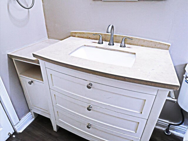 bathroom with hardwood / wood-style floors and vanity