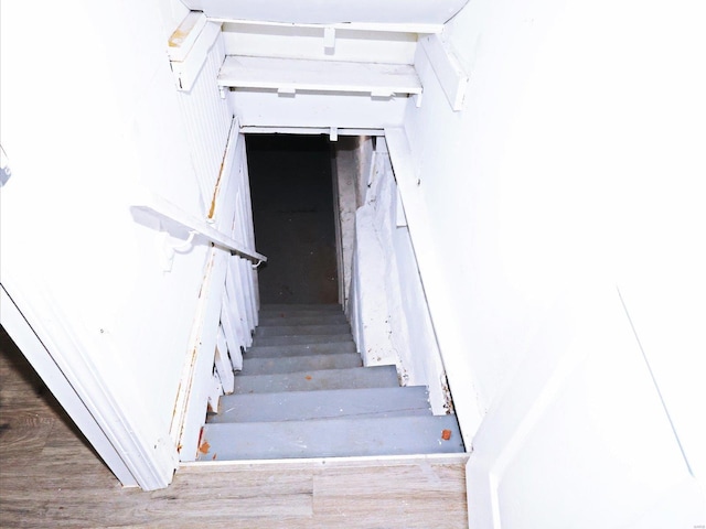 stairs featuring hardwood / wood-style flooring