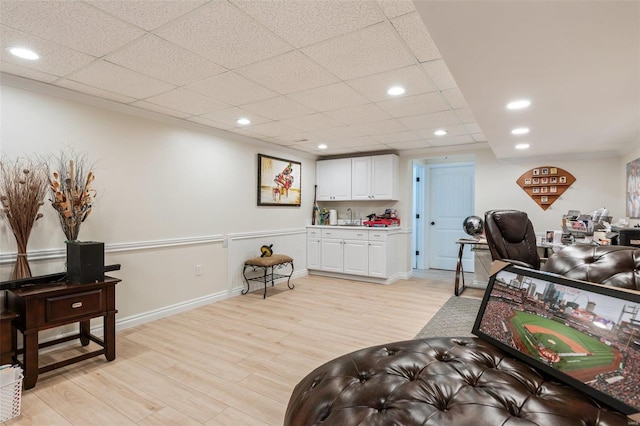 interior space featuring light wood-style floors, recessed lighting, a paneled ceiling, and baseboards