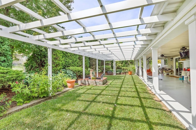 view of yard featuring a ceiling fan, a patio, and a pergola