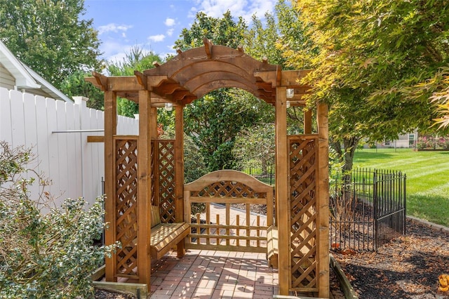 wooden terrace with a lawn and fence