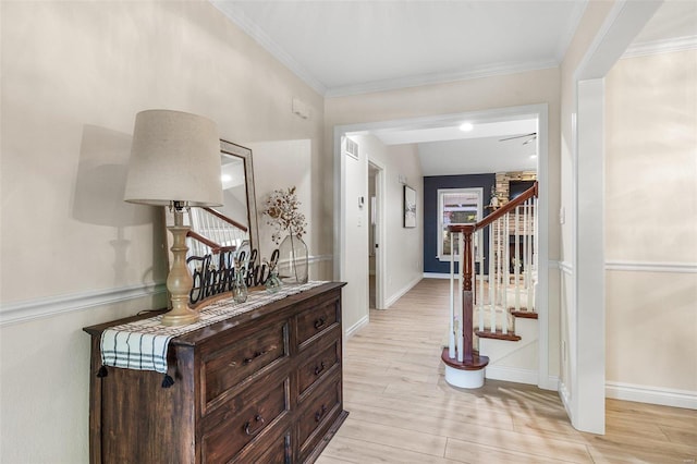 foyer with stairs, light wood-type flooring, baseboards, and crown molding