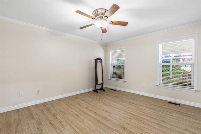 unfurnished room with baseboards, visible vents, crown molding, and light wood finished floors