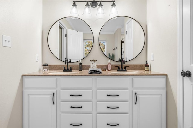 bathroom with crown molding, a sink, and double vanity