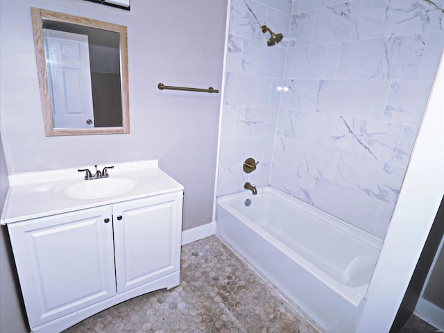 bathroom with tile patterned flooring, tiled shower / bath, and vanity