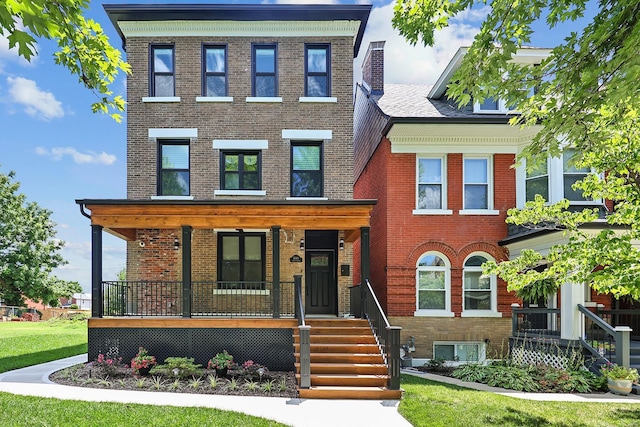 view of front of home featuring covered porch and brick siding