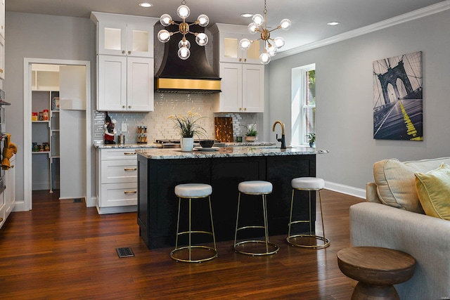 kitchen featuring backsplash, dark hardwood / wood-style flooring, and light stone counters