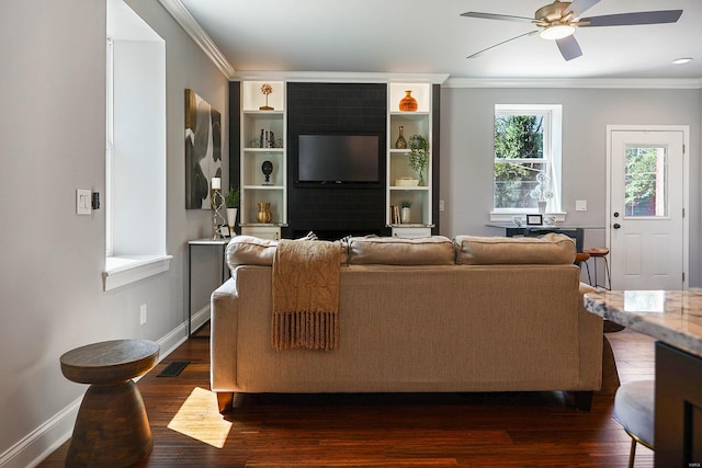 living room featuring built in shelves, ornamental molding, dark hardwood / wood-style floors, and ceiling fan