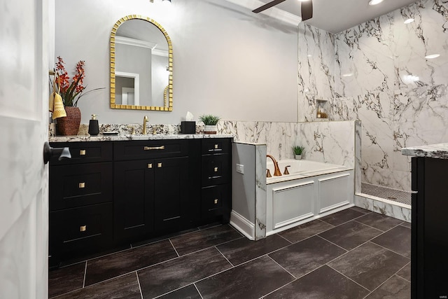 bathroom featuring tile patterned floors, ceiling fan, vanity, and a bathing tub