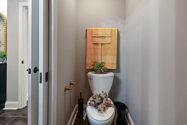 bathroom featuring toilet and tile patterned flooring