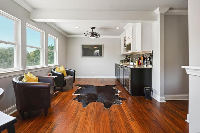 living room with wine cooler, dark hardwood / wood-style flooring, and crown molding