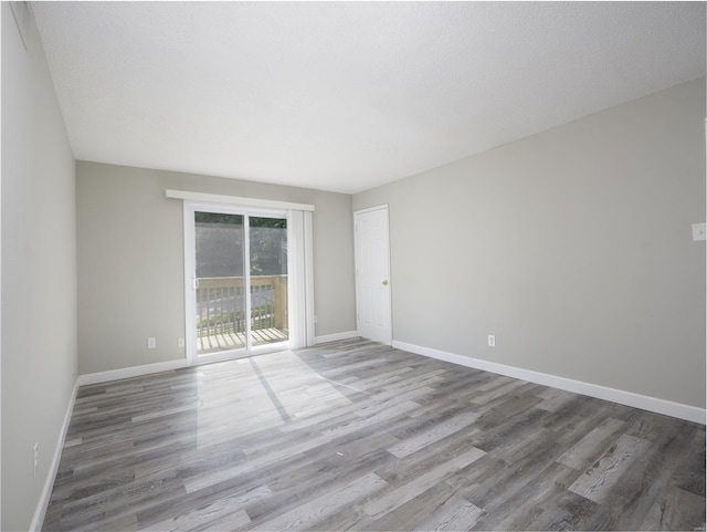 empty room featuring baseboards and wood finished floors