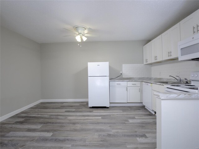 kitchen with ceiling fan, white appliances, decorative backsplash, and light hardwood / wood-style floors