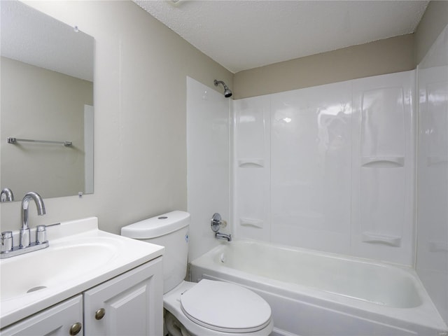 full bath with a textured ceiling, toilet, vanity, and shower / bathing tub combination