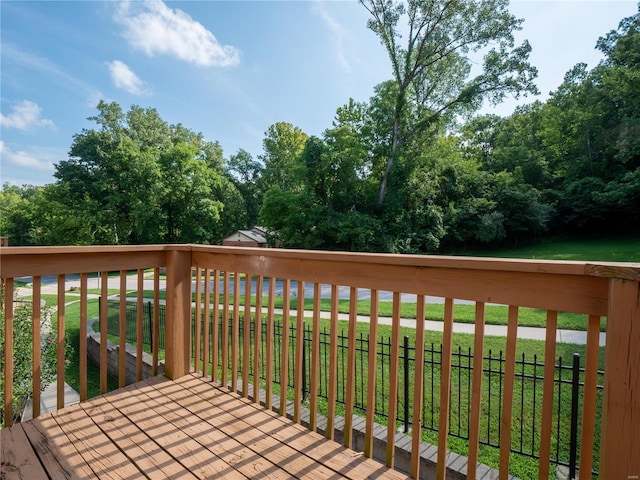 wooden terrace featuring a lawn