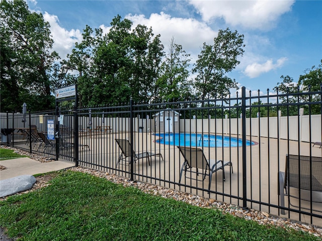 pool featuring an outbuilding and fence