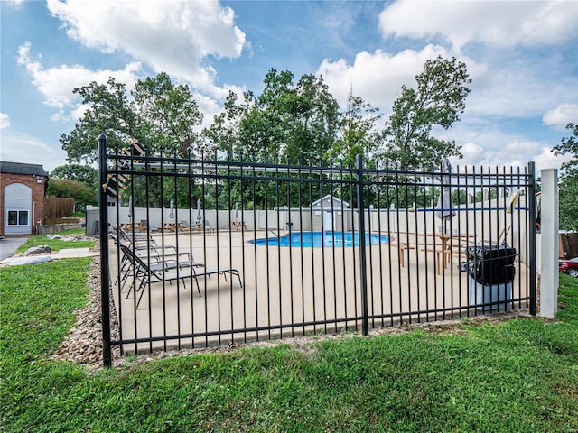 view of gate featuring a community pool and fence