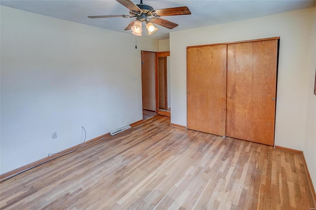 unfurnished bedroom featuring ceiling fan, light hardwood / wood-style flooring, and a closet