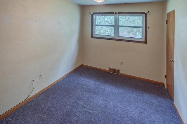 spare room featuring carpet