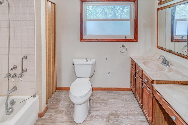 full bathroom featuring a wealth of natural light, toilet, tiled shower / bath combo, and vanity