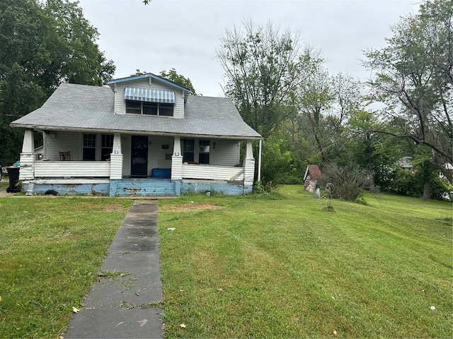 bungalow-style home with a front yard and a porch