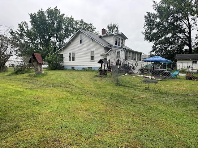 back of property featuring a yard